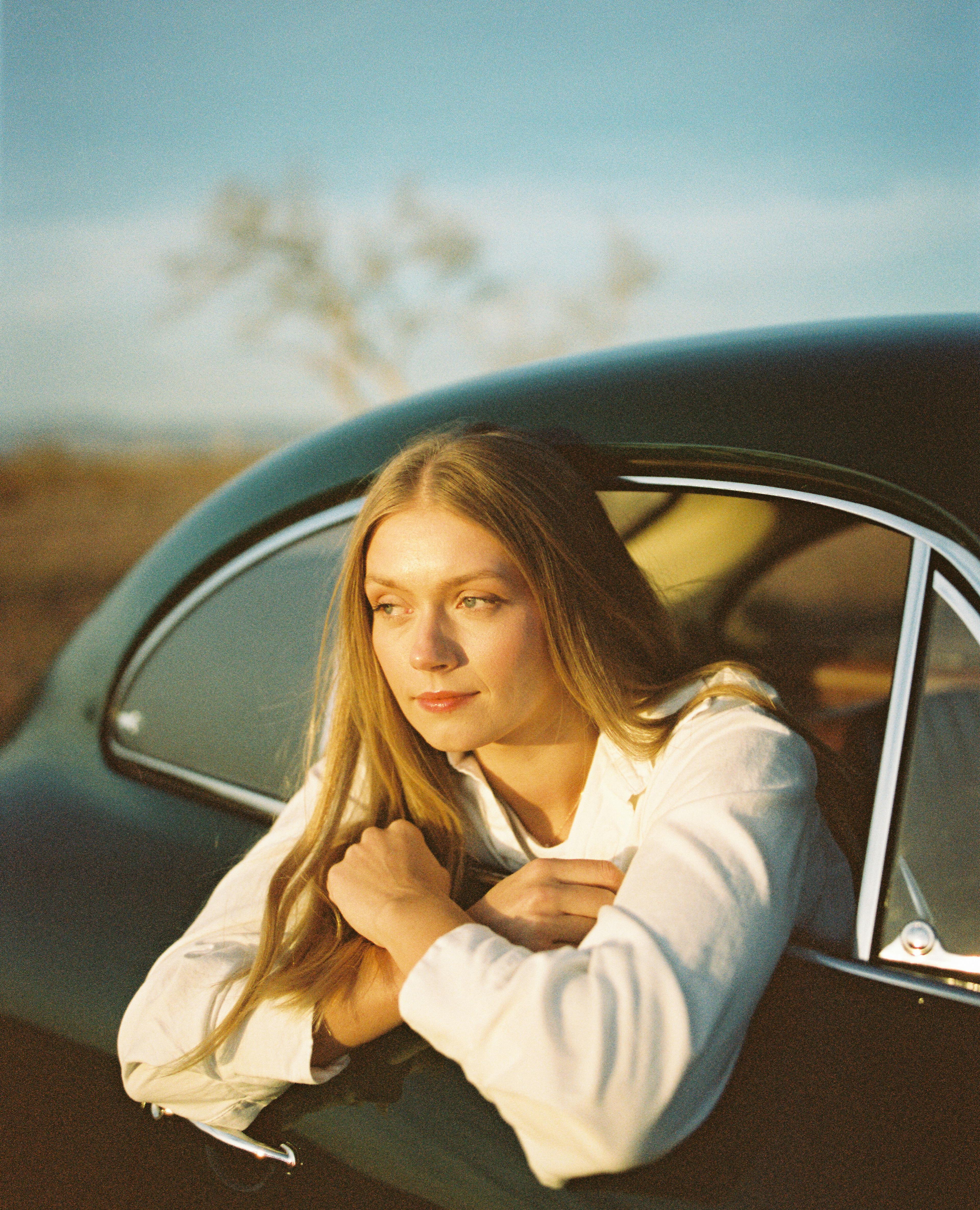 KJ in a vintage car at sunset shot by Natalie Carrasco.