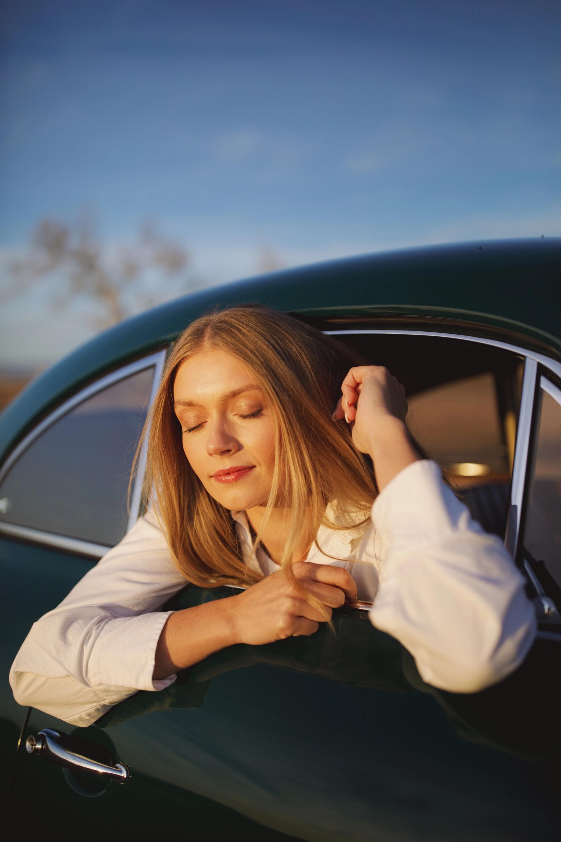 KJ in a vintage car at sunset shot by Natalie Carrasco.