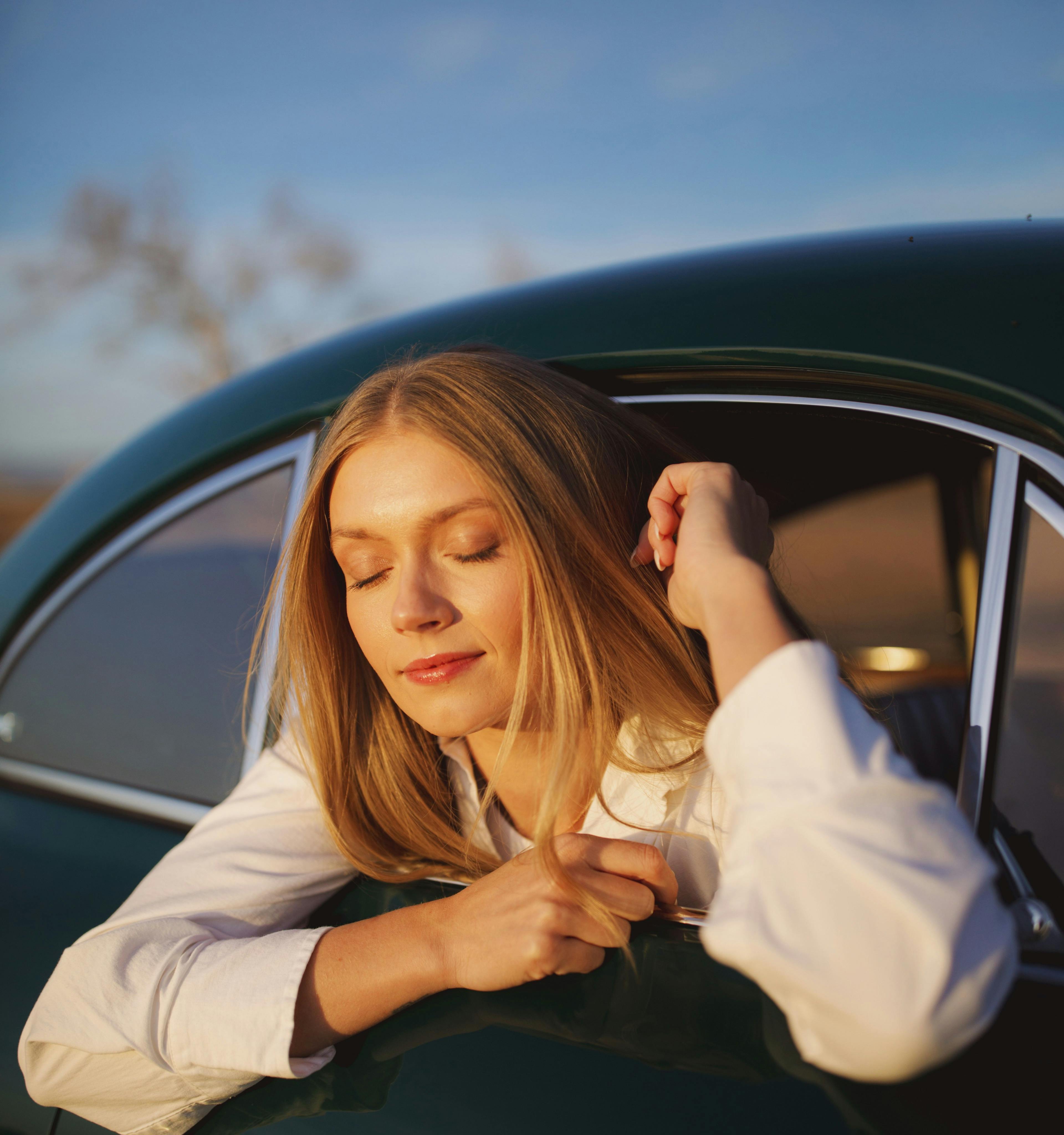 KJ in a vintage car at sunset shot by Natalie Carrasco.