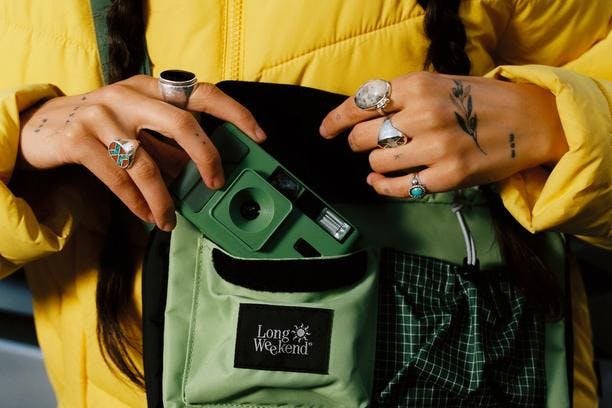 The Long Weekend Moss shoulder bag over a yellow jacket in California, shot by Willem.