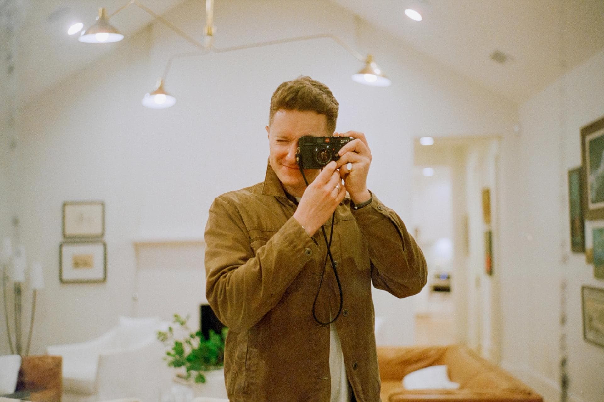 Self-portrait on my Leica film camera.